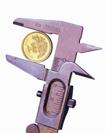 Pound coin in pliers