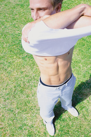 Man taking off shirtの写真素材