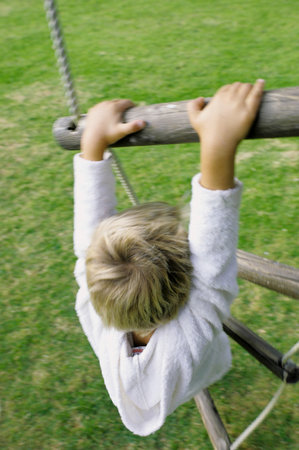 Boy climbing rope ladderの写真素材