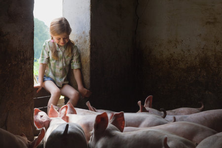 A girl and pigs in a pigsty