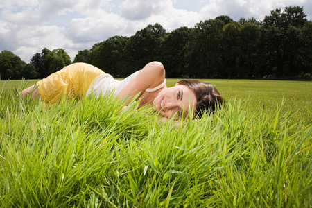 Woman lying in fieldの写真素材