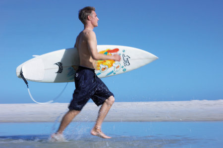 Surfer runningの写真素材