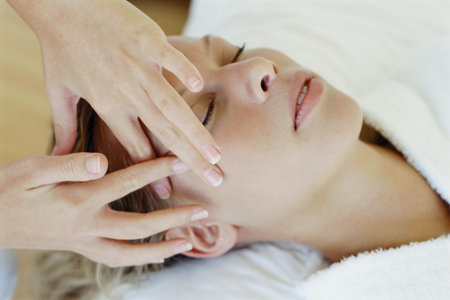 Woman receiving facial massageの写真素材