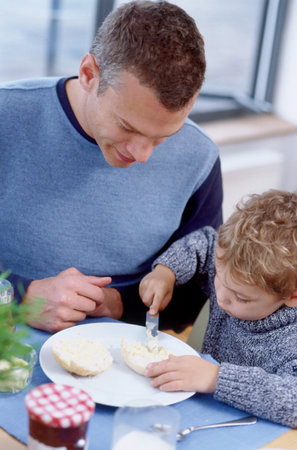 Father and son at breakfastの写真素材