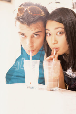 Couple drinking milkshakesの写真素材
