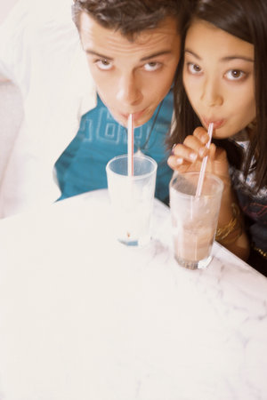 Couple drinking milkshakesの写真素材