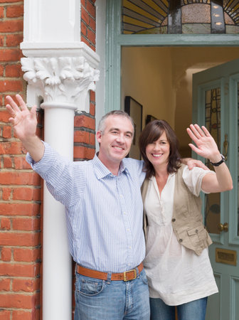 Mature man and woman wavingの写真素材