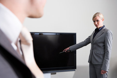 Businesswoman with televisionの写真素材