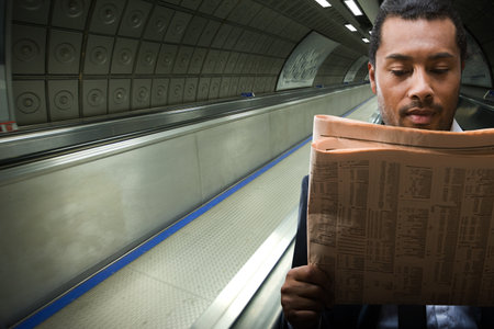 A businessman reading a newspaperの写真素材