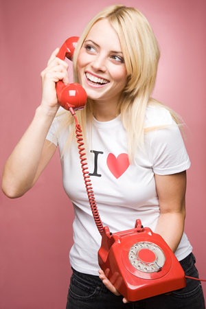 A young woman holding a telephoneの写真素材