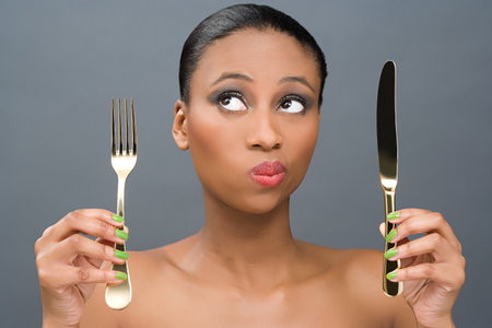 Woman holding a knife and forkの写真素材
