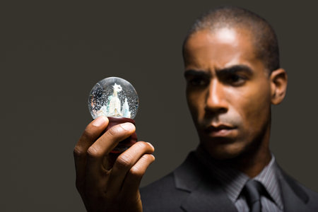 Businessman with snowglobeの写真素材