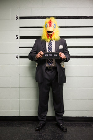 Mugshot of businessman with chicken head