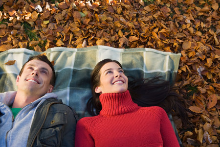 Couple lying on leavesの写真素材