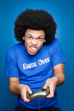 A young man playing a video gameの写真素材