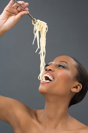 Woman eating spaghettiの写真素材