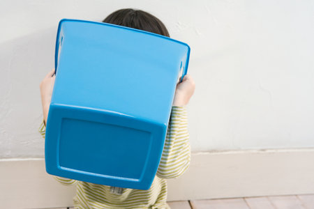 A boy holding a recycling binの写真素材