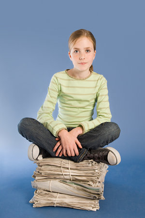Girl with newspapersの写真素材