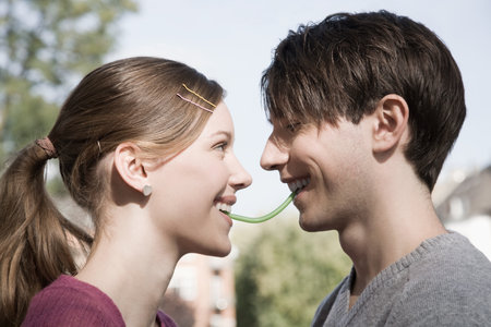Young couple sharing a sweetの写真素材