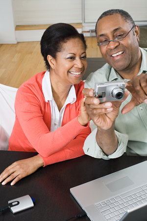 Mature couple with digital cameraの写真素材