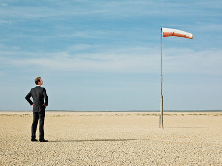 Businessman looking at a windsockの写真素材