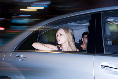 Couple travelling in a speeding carの写真素材