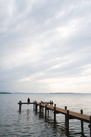 Woman sitting on a jetty