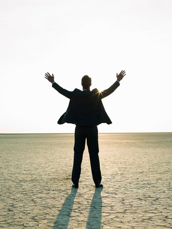 Businessman reaching to the sunlightの写真素材