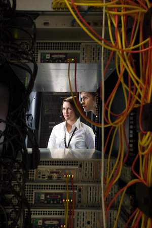 Two computer technicians and a network server