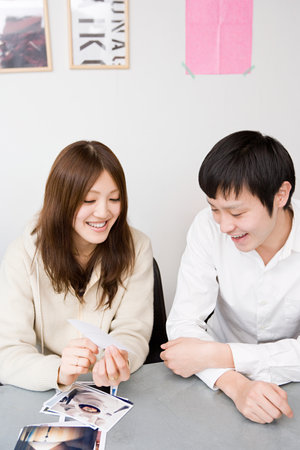 Woman and man looking at photographsの写真素材