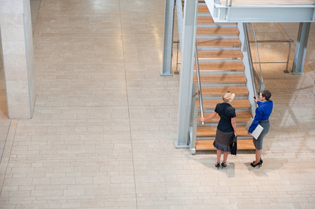 Businesswomen by stairwellの写真素材