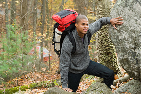 Young man in forest with backpack