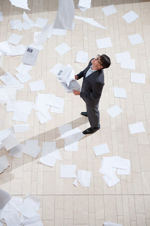 Businessman throwing papersの写真素材