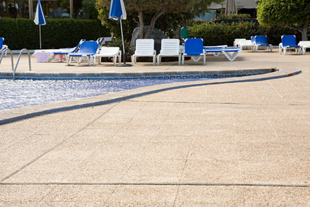 Sun loungers beside a swimming poolのeditorial素材