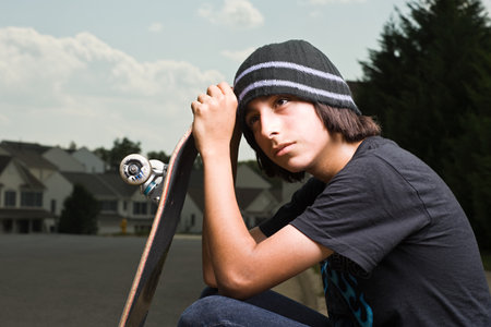 Teenage boy with a skateboardの写真素材