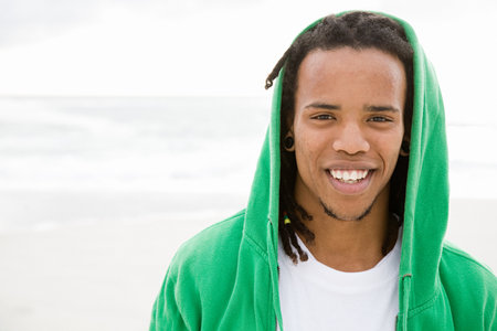 Young man with green hooded top, portraitの写真素材