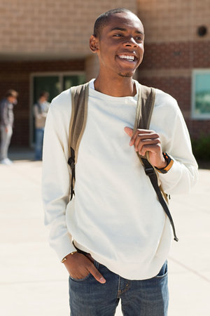 Male high school student outside school buildingの写真素材