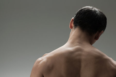 Muscular mature man, rear viewの写真素材