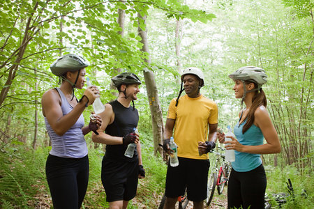 Four cyclists in forestの写真素材