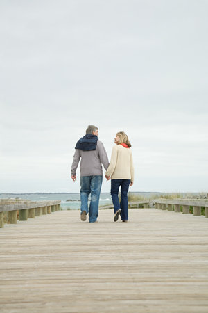 Couple holding hands on walkwayの写真素材