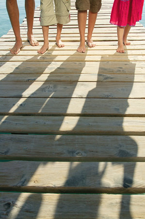 Shadows of family on a jettyの写真素材