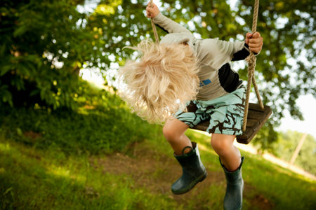 Young boy on swingの写真素材