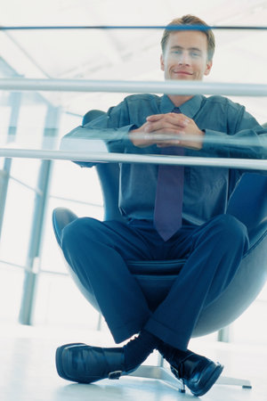 Businessman in office chairの写真素材