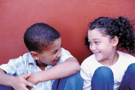 Boy and girl against wall