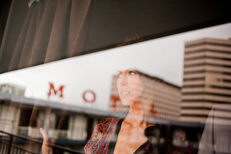 Young woman in motel window
