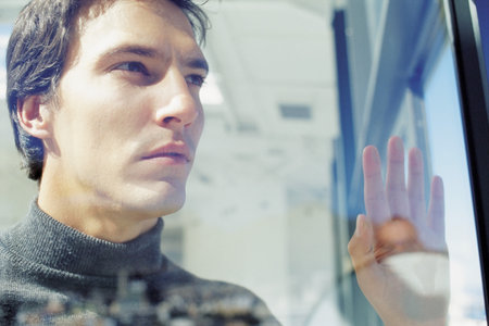 Businessman looking through window