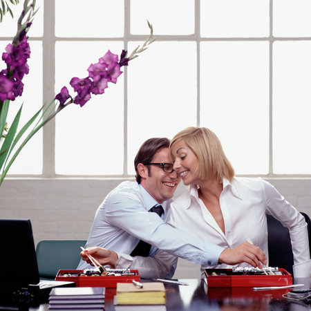 Eating and flirting at workの写真素材