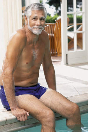 Man on the edge of swimming poolの写真素材