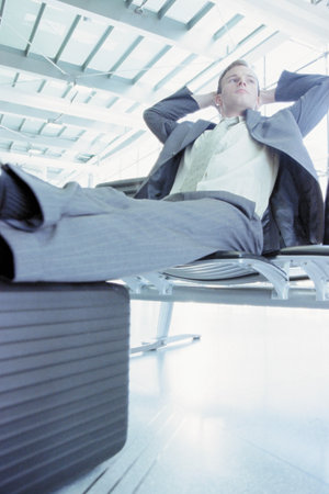Businessman waiting in airport loungeの写真素材