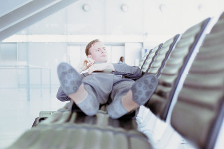 Businessman relaxing in airport loungeの写真素材